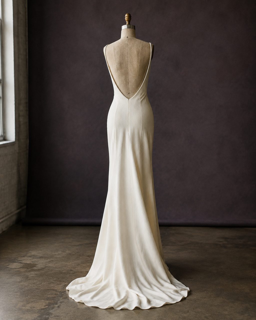 The Crepe Column: an ivory silk crepe bias-cut gown with a low back on a dress form.